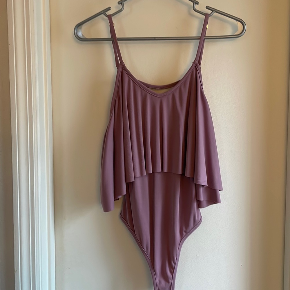 Mauve bodysuit with spaghetti strap. Snap button closure.